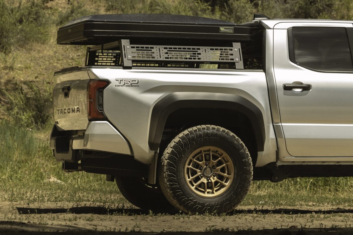 Silver off-road truck with mounted cargo rack.