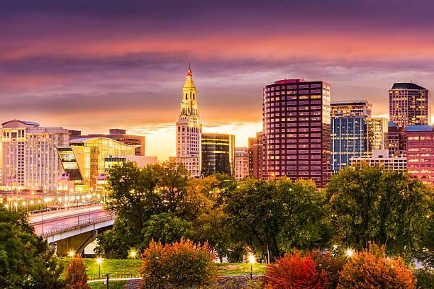 Hartford skyline at sunset with colorful sky wheels and tires