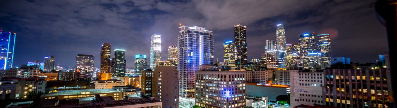 Colorful city skyline at night with glowing lights.