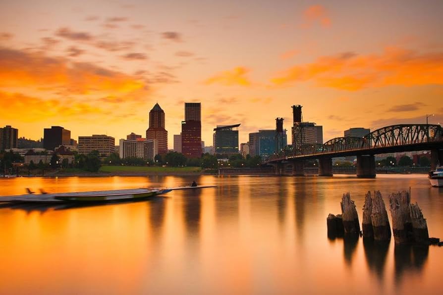 Portland skyline at sunset with bridge reflection.