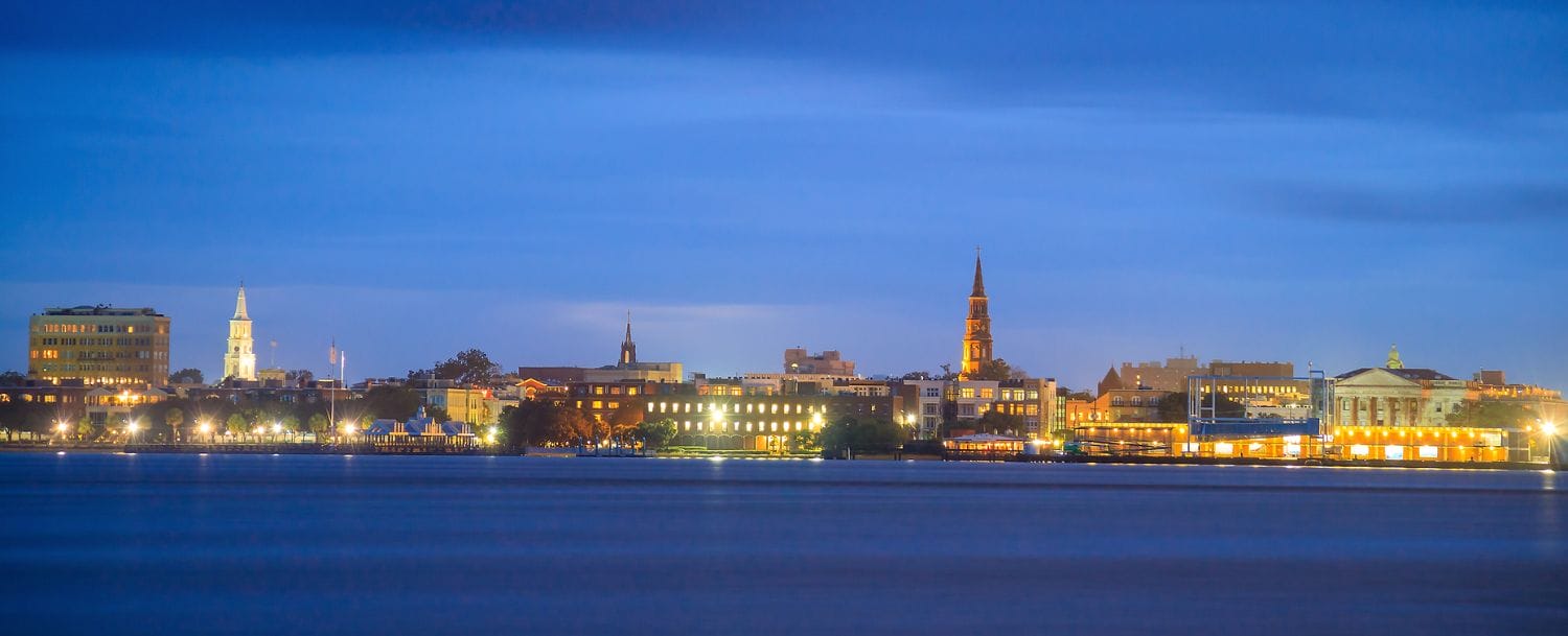 Charleston skyline at dusk with lit buildings