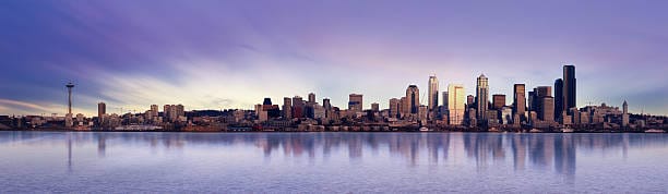 Seattle skyline at dusk reflected on water