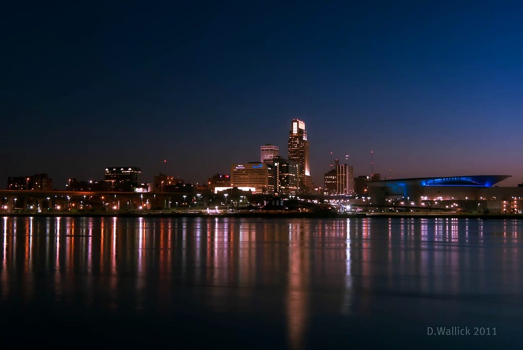 Omaha skyline at night with reflections.