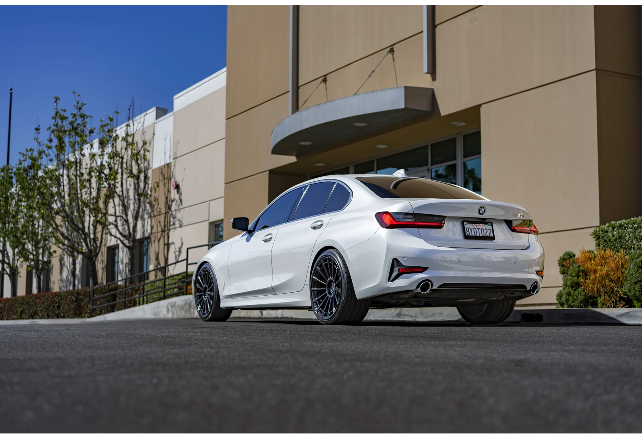 White sedan parked outside office building BMW 3 Series Wheels