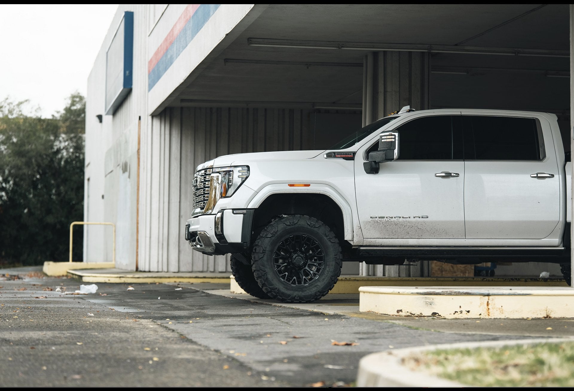 White pickup truck parked outside commercial building.