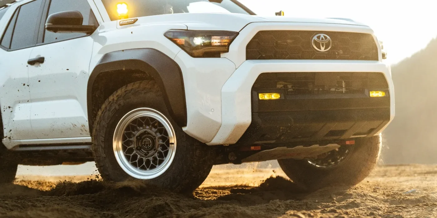 White truck driving on sandy terrain