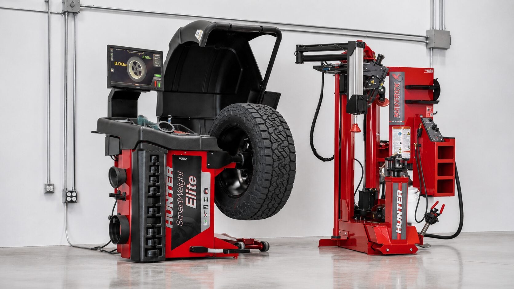 Tire changing and balancing machines in workshop.